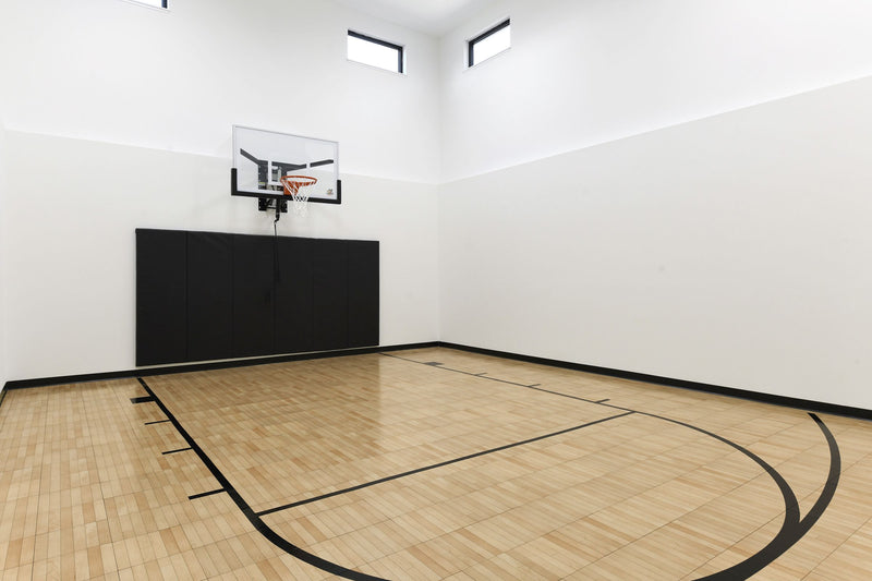 Gladiator wall-mounted basketball hoop installed in an indoor court