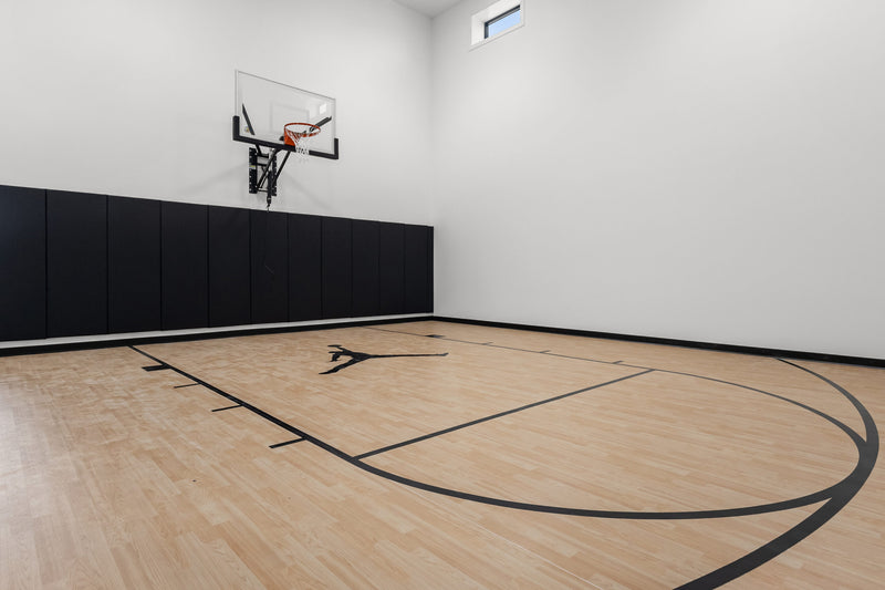 Gladiator wall-mounted basketball hoop installed in an indoor court