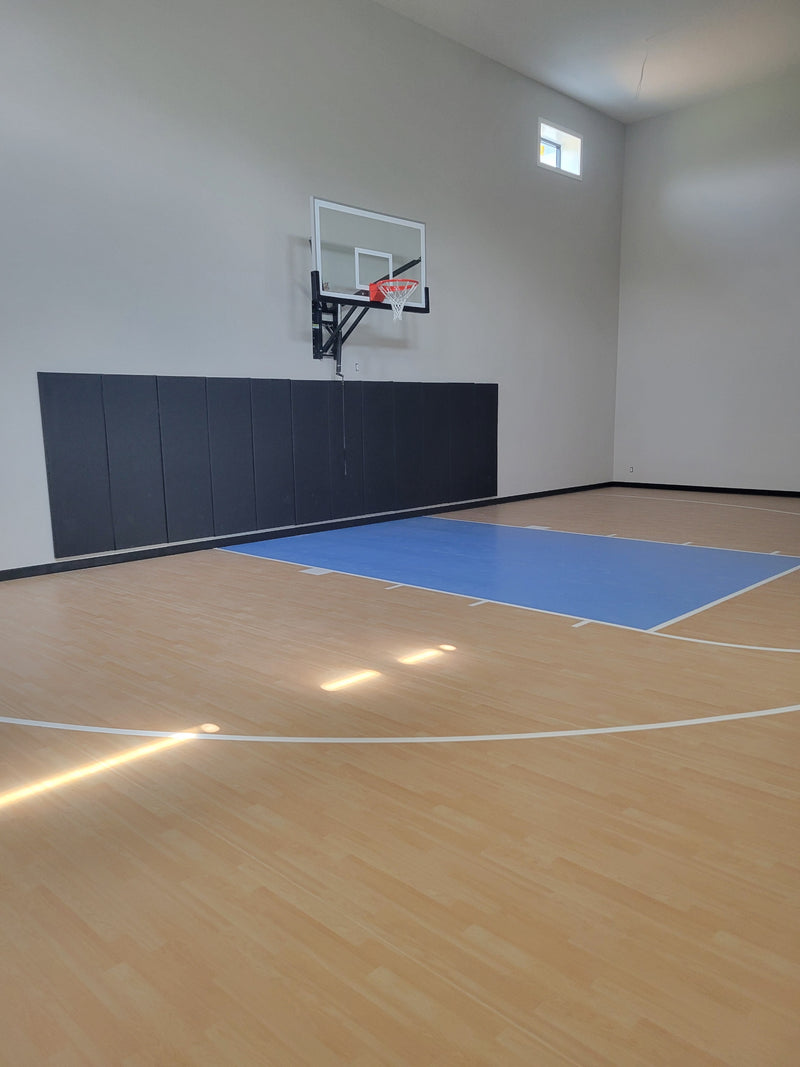 Gladiator wall-mounted basketball hoop installed in an indoor court