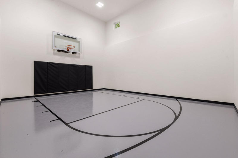 Gladiator wall-mounted basketball hoop installed in an indoor court