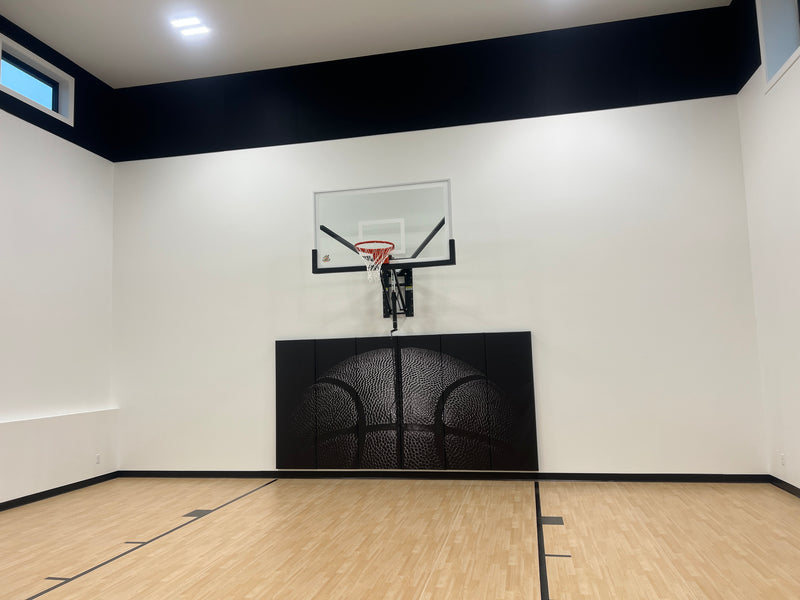 Gladiator wall-mounted basketball hoop installed in an indoor court