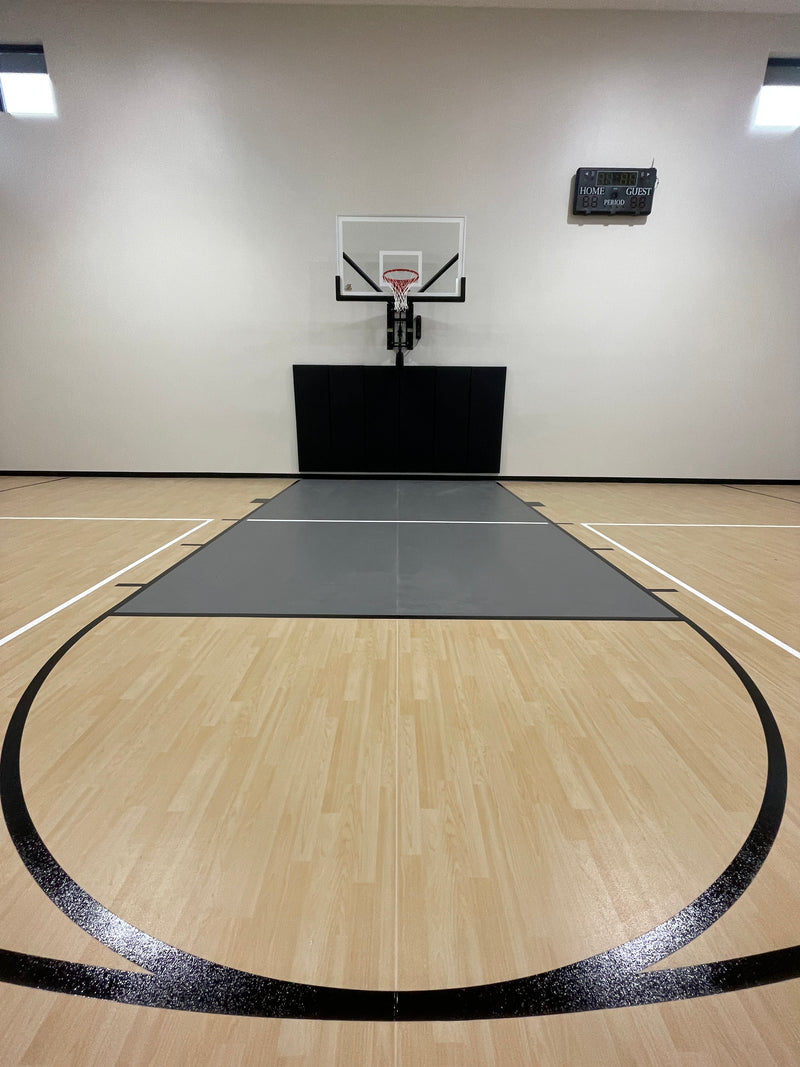 Gladiator wall-mounted basketball hoop installed in an indoor court
