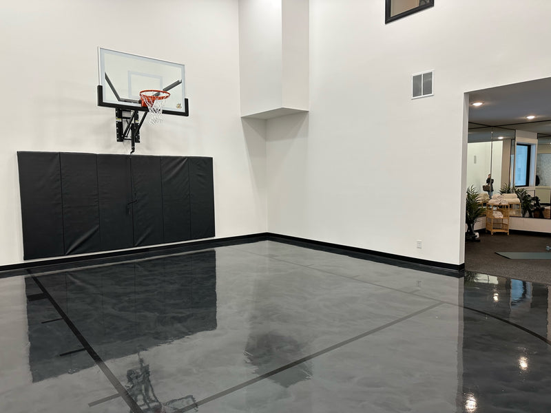 Gladiator wall-mounted basketball hoop installed in an indoor court