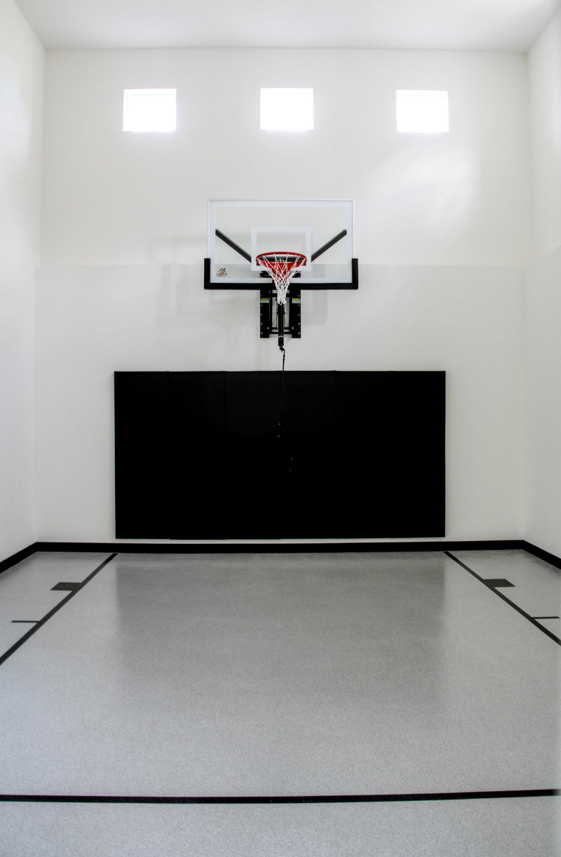 Gladiator wall-mounted basketball hoop installed in an indoor court