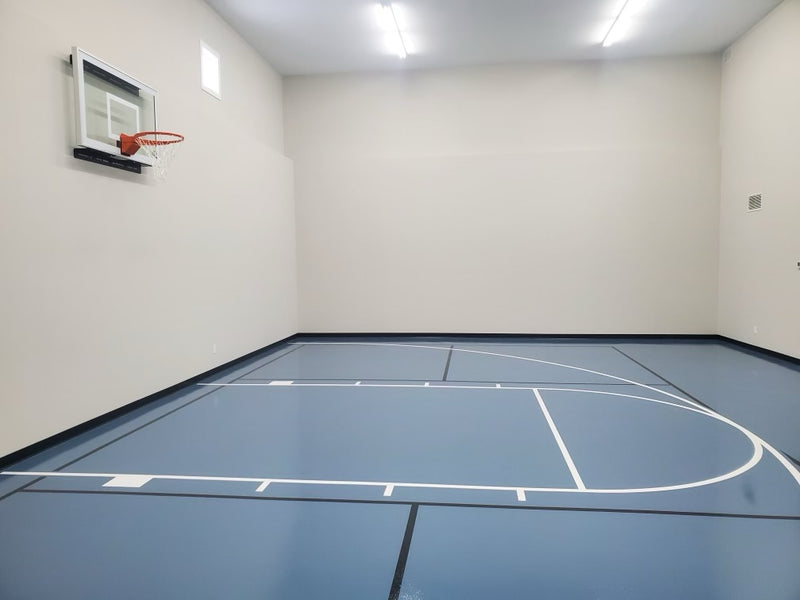 Gladiator wall-mounted basketball hoop installed in an indoor court