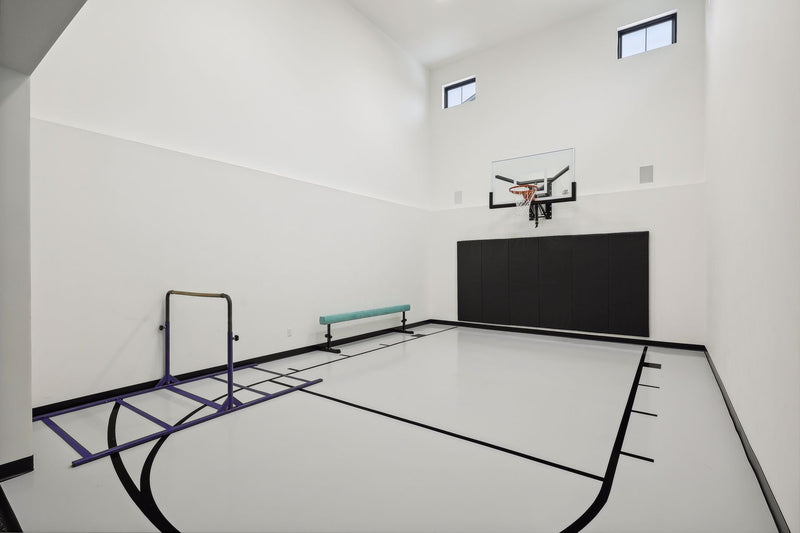Gladiator wall-mounted basketball hoop installed in an indoor court